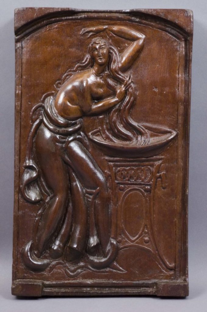 wood relief sculpture of a woman washing her hair by Elie Nadelman