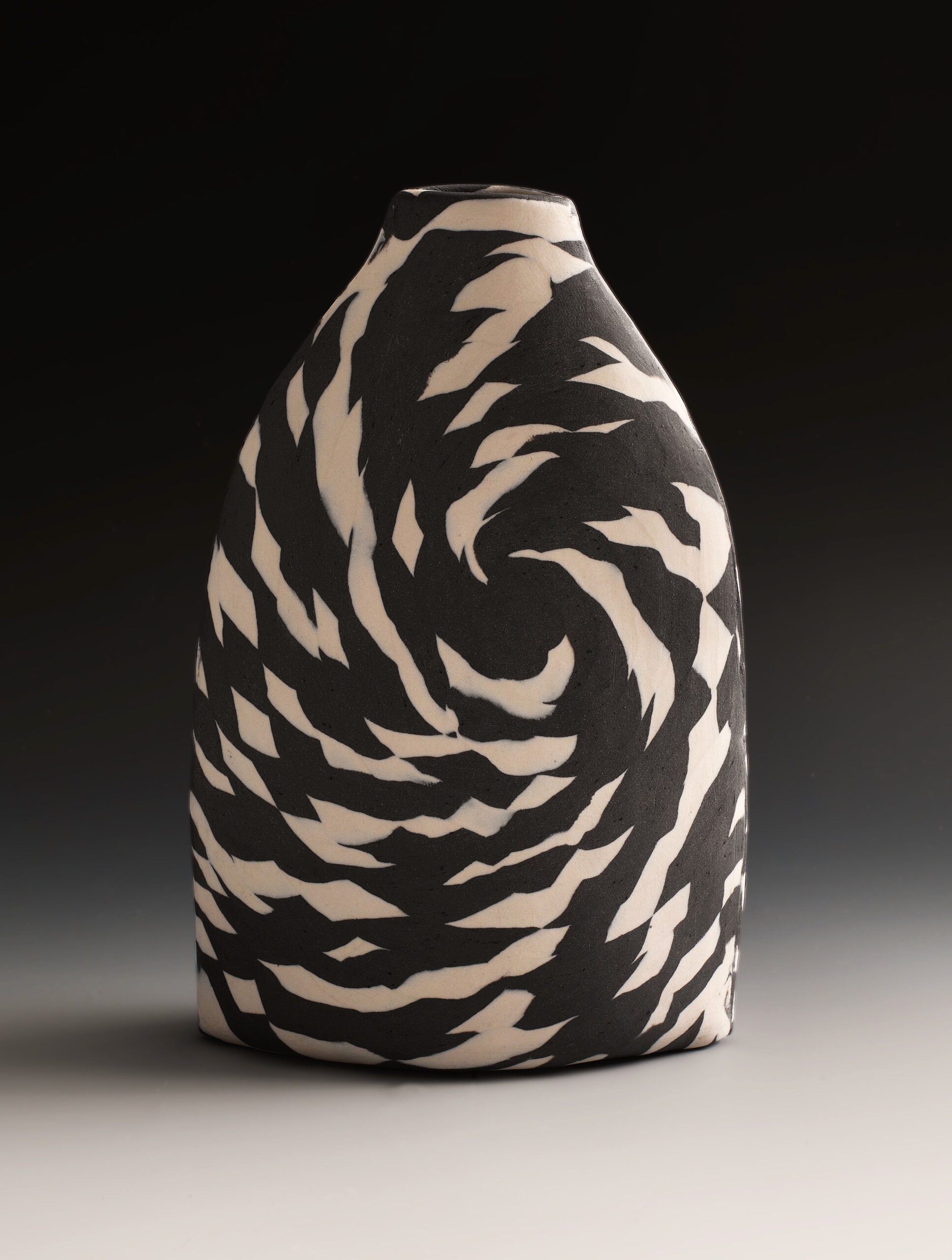 
							

									Lorraine Shemesh									Black & White Tall Twist Nerikomi Bottle 2021									porcelain<br />
11 x 8 x 2 3/4 inches									


							