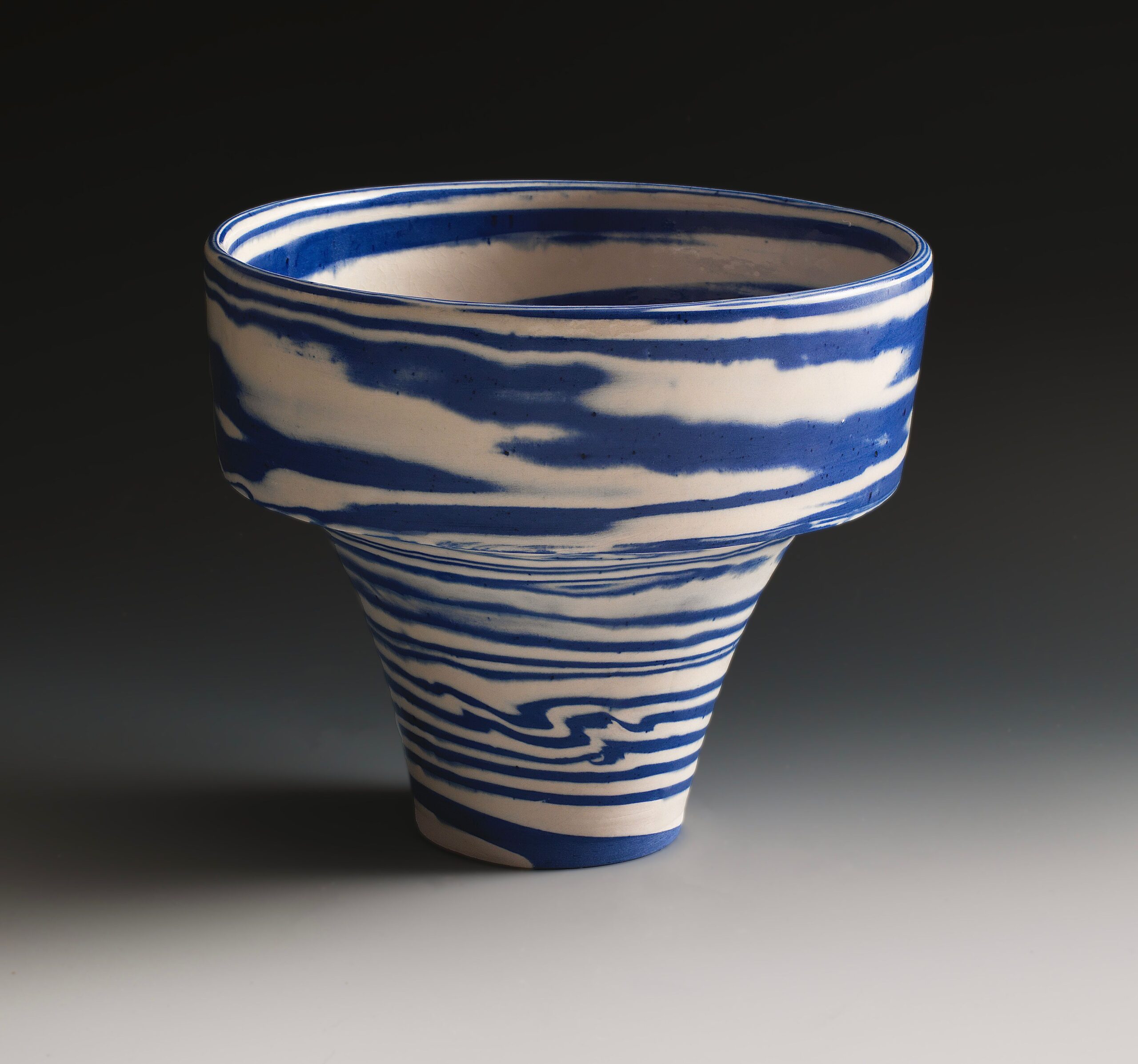 
							

									Lorraine Shemesh									Blue & White Swirl Ledge Neriage Vessel 2021									porcelain<br />
7 1/2 x 8 1/4 x 8 1/2 inches									


							