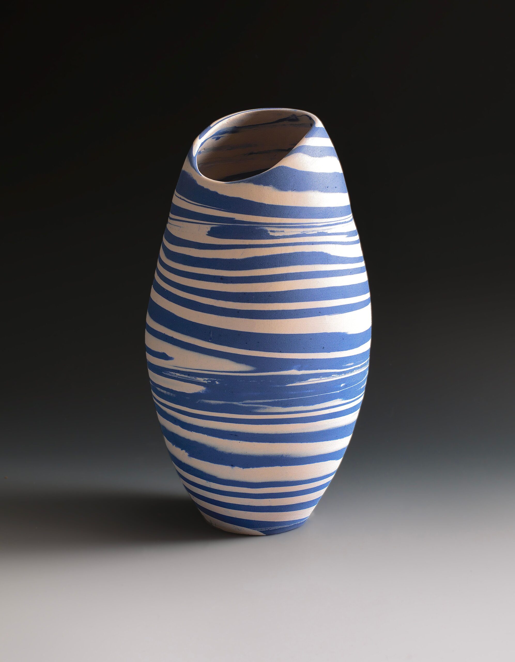 
							

									Lorraine Shemesh									Blue & White Swirl Neriage Oblong Vessel 2021									porcelain<br />
11 x 6 1/2 x 6 1/2 inches									


							